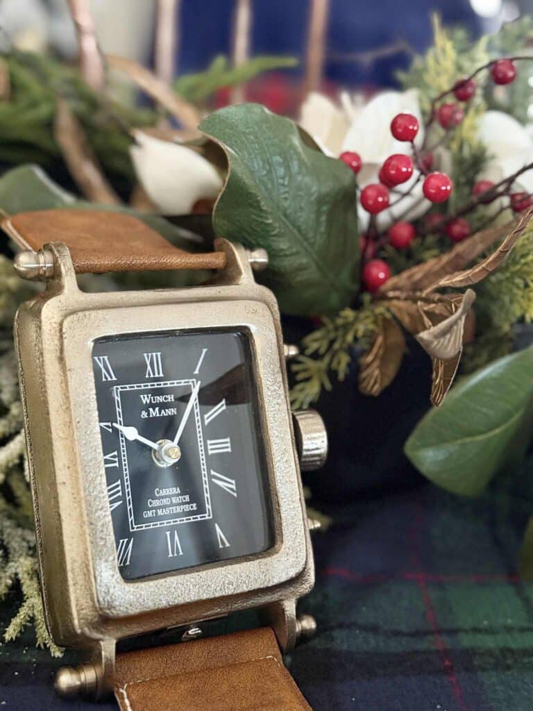 Leather trimmed watch sitting on a coffee table decorated for Christmas.