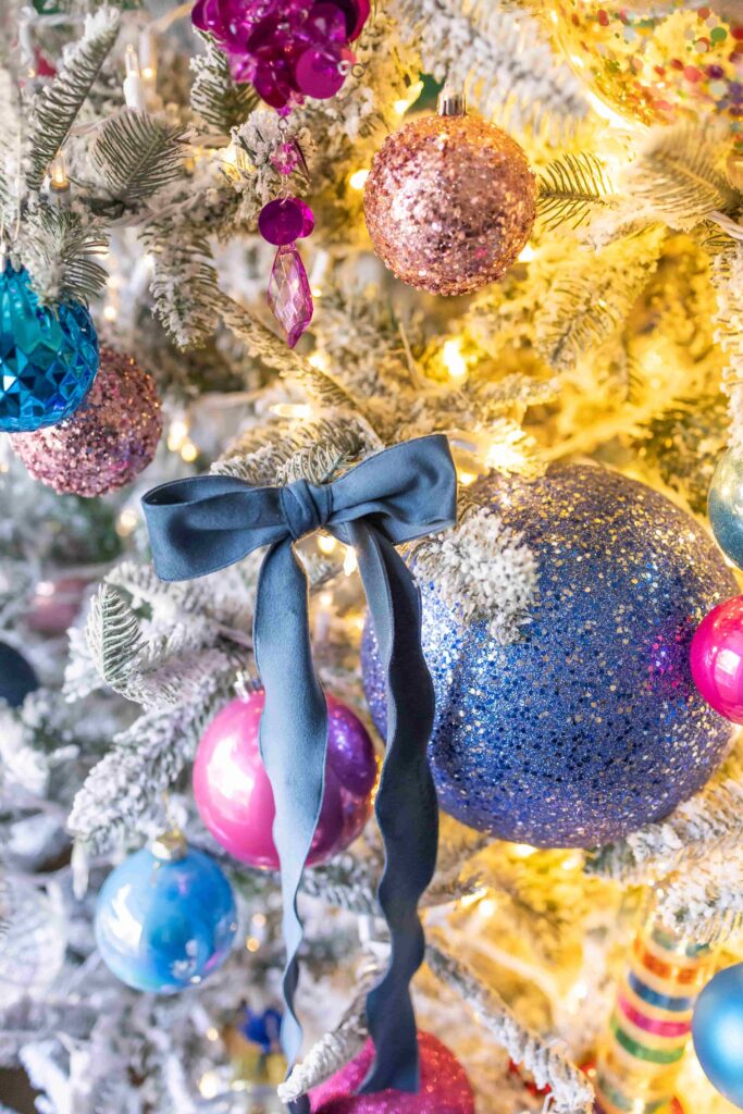 Blue velvet bows clipped to a Christmas tree.