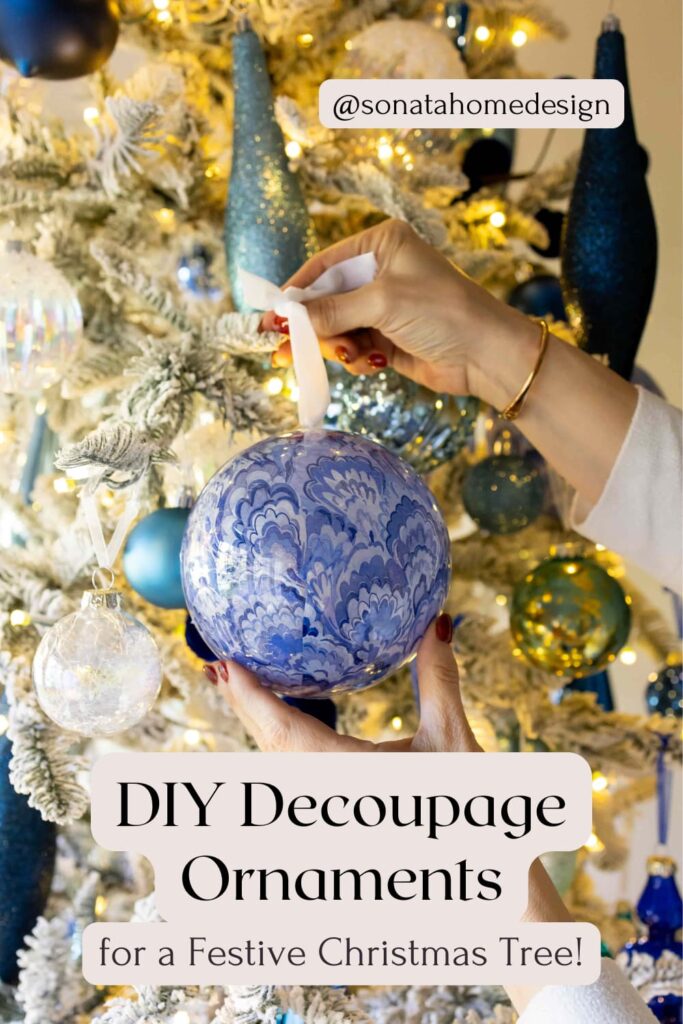 woman hanging decoupage Christmas ornament on flocked tree.