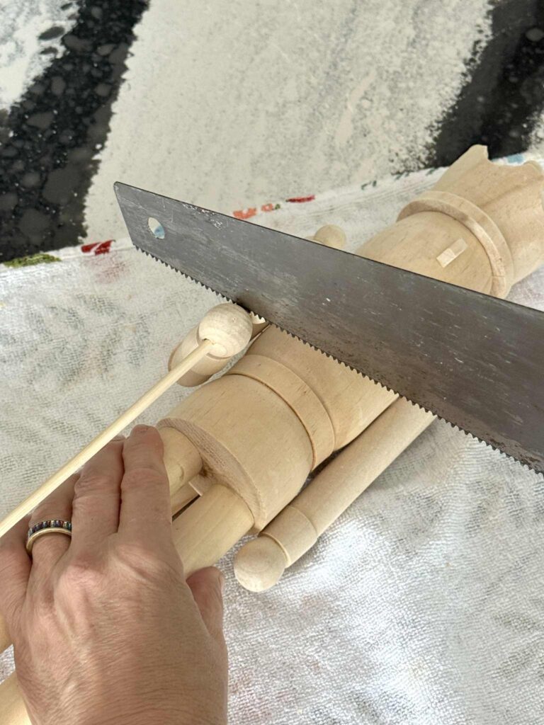 Sawing the club from a wood nutcrackers hand.