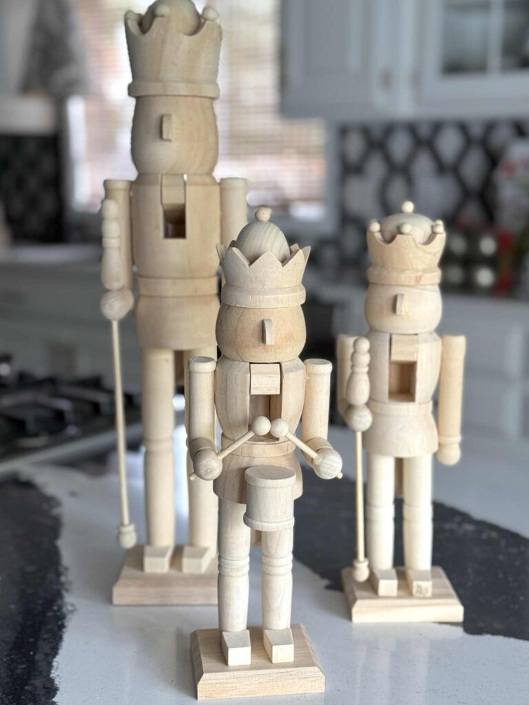 Three unfinished wood nutcrackers.