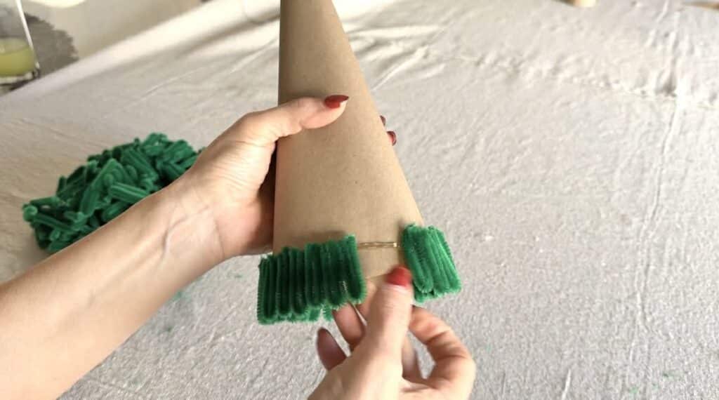 gluing pipe cleaner loops to bottom of Christmas tree cone.