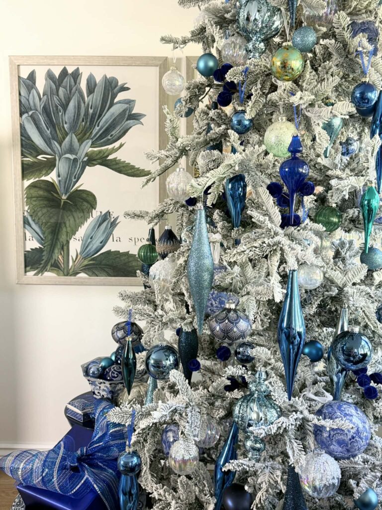 blue Christmas decorating ideas include a flocked tree.