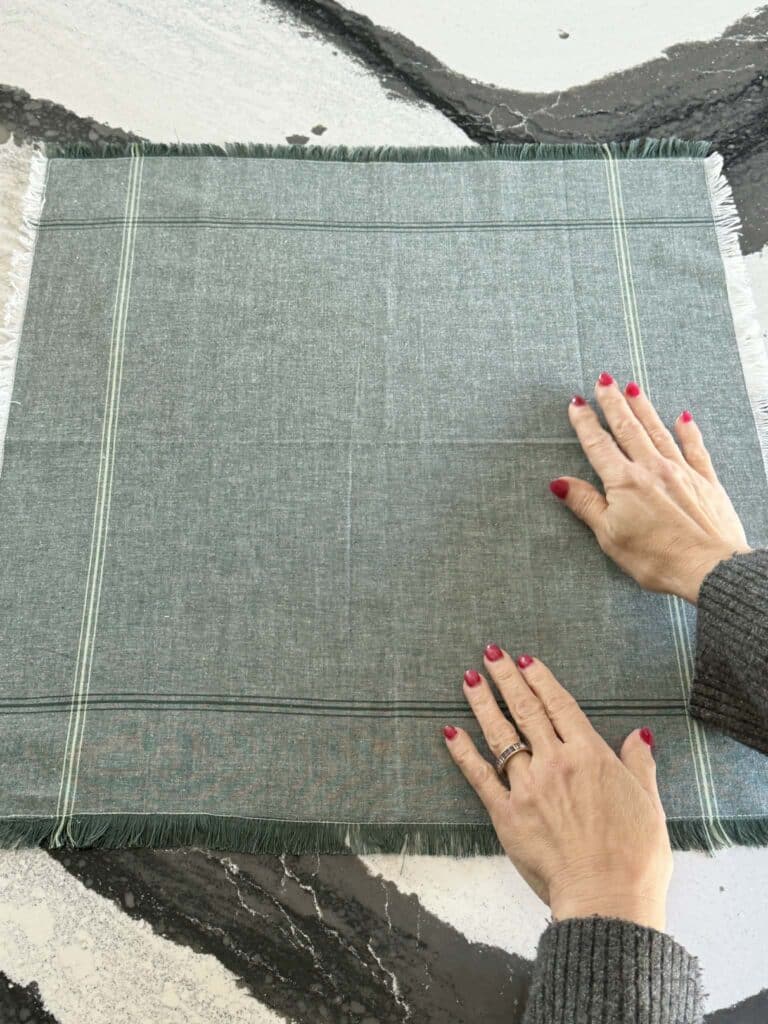 A square, green cloth napkin.