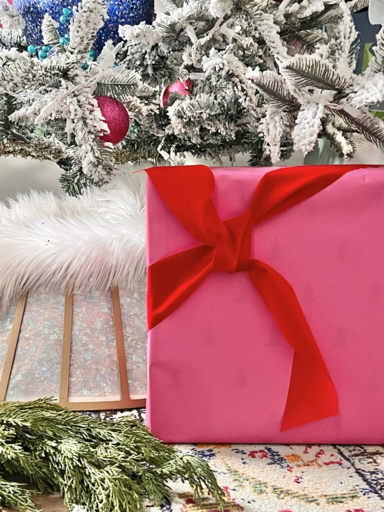 Christmas gift wrapping ideas include this package wrapped in hot pink paper with a red velvet ribbon.