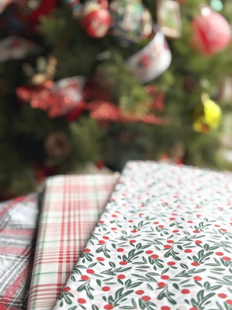Tissue paper in a plaid pattern and a berry sprig pattern.