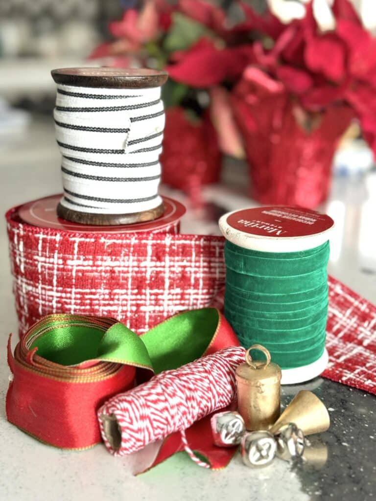 Spools of Christmas ribbon, twine, and bells.
