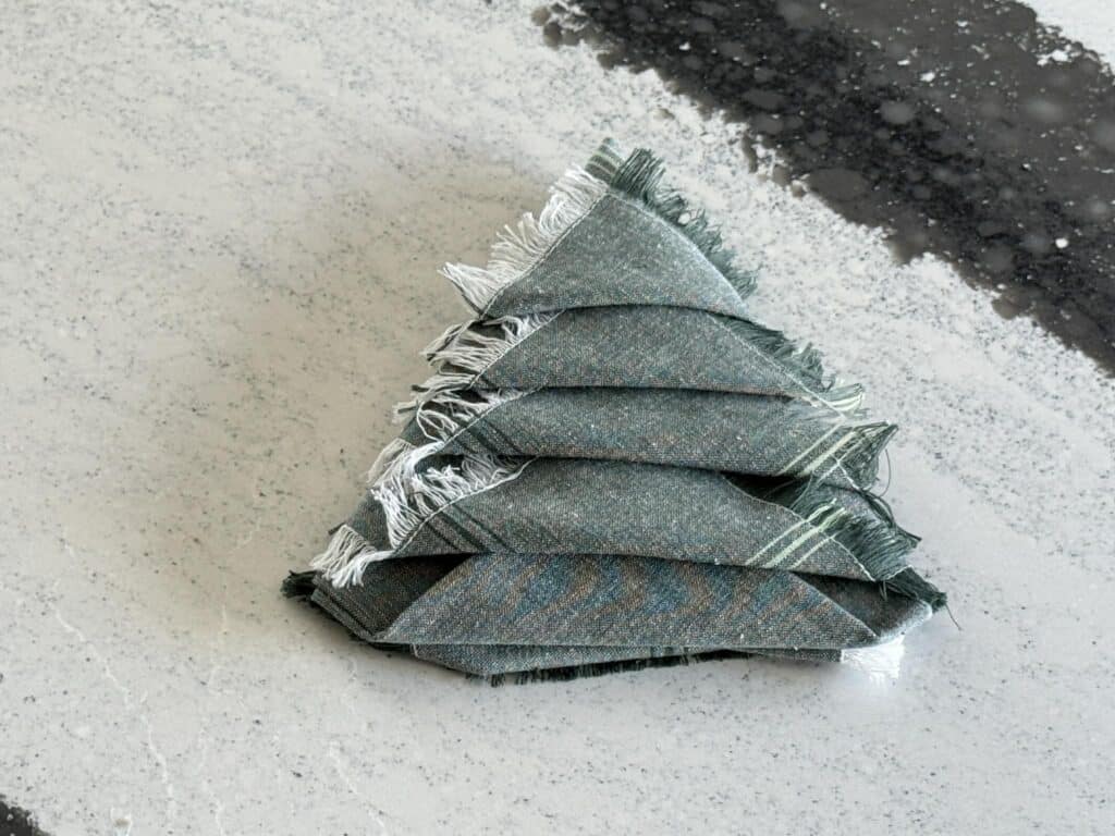 A Christmas tree napkin fold triangle shape.