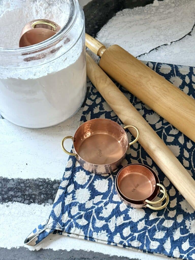 Copper measuring cups and wood rolling pins: How to Warm Up a White Kitchen