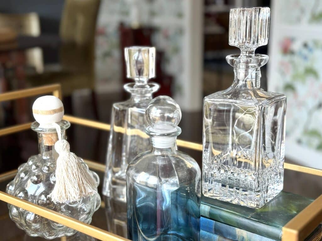 Glass decanters on a bar cart.