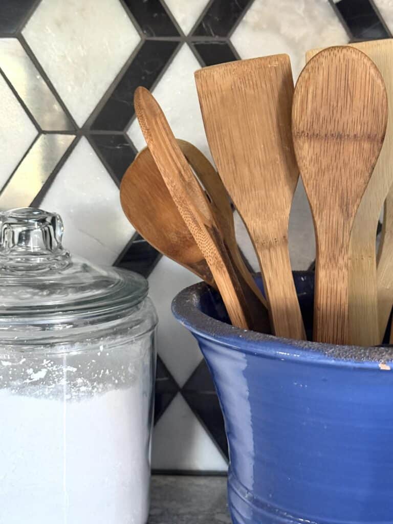 Wooden spoons in a blue crock.