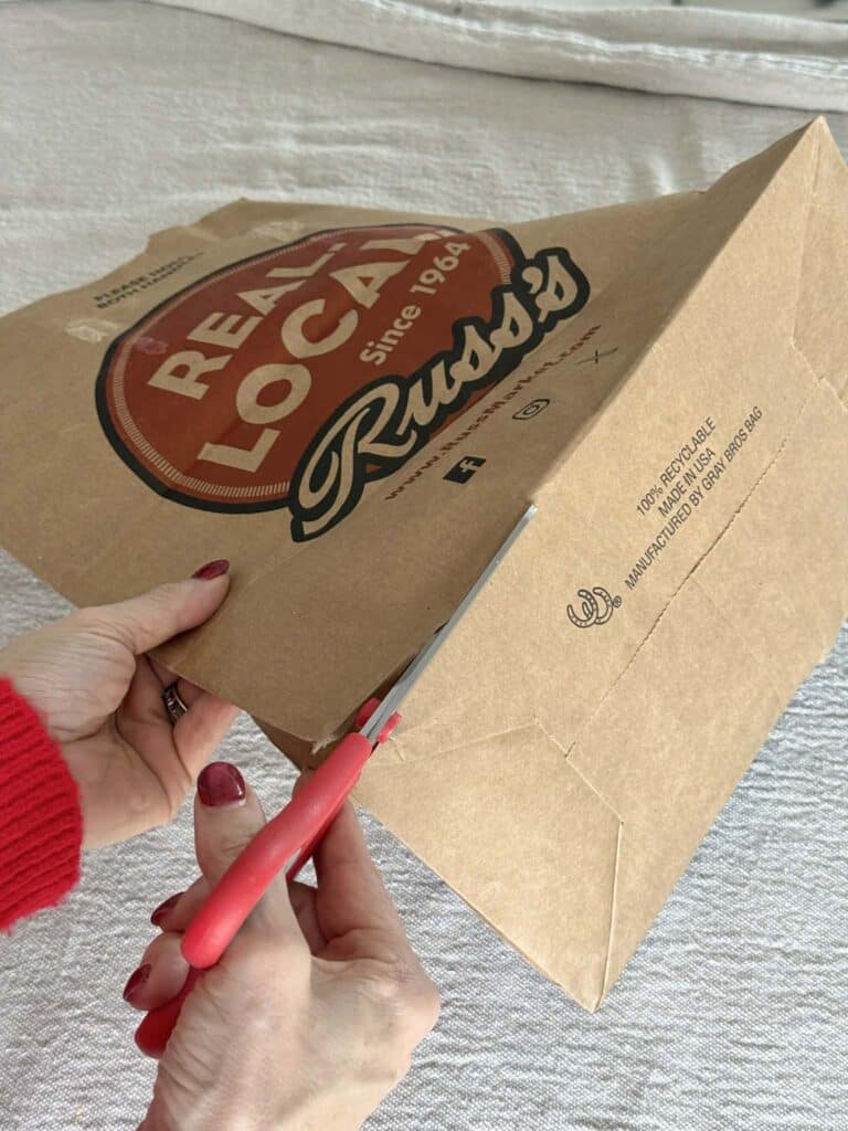 Cutting a paper bag with scissors.