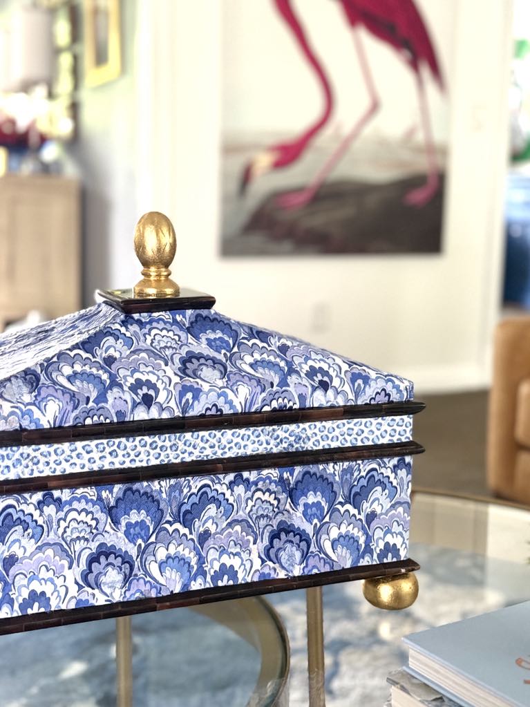 A blue and white decorative box in a living room.