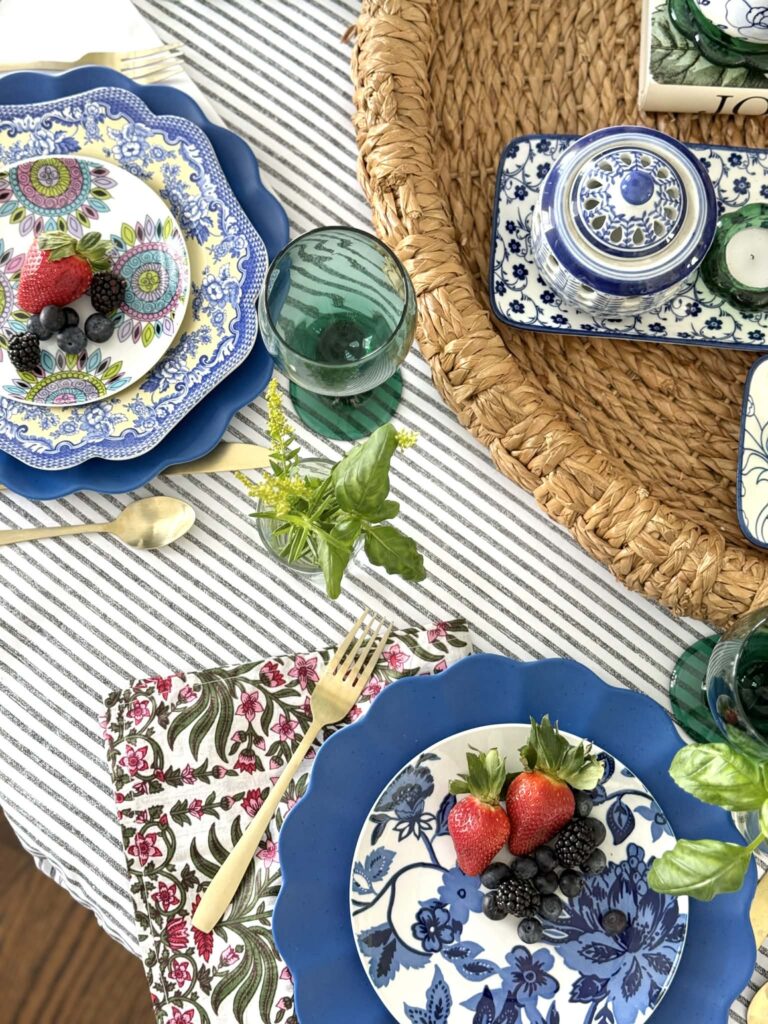 Mismatched plates and napkins layered on a spring table.
