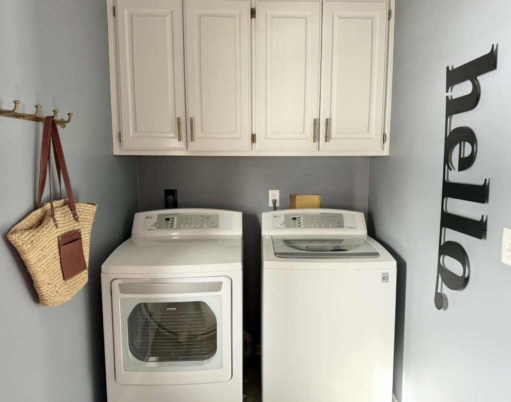 Washer and dryer with exposed, ugly washer hookup behind it.
