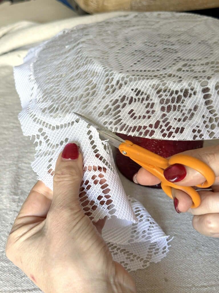 Trimming excess lace from decoupage plates.