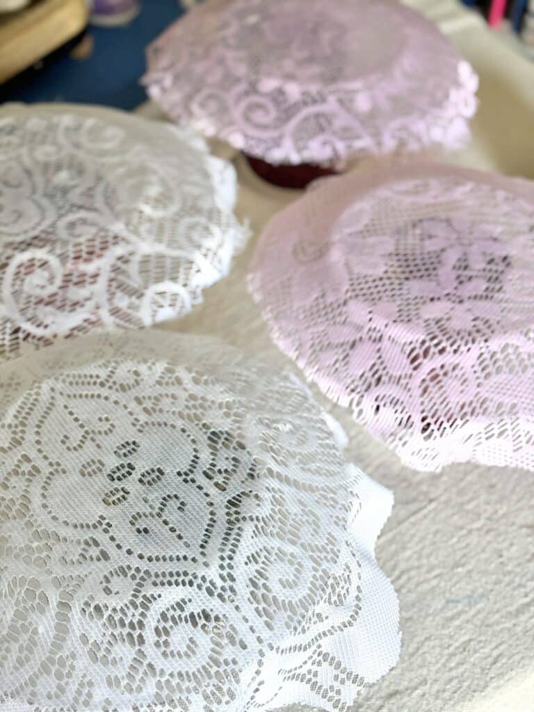Lace covered plates with decoupage glue drying.