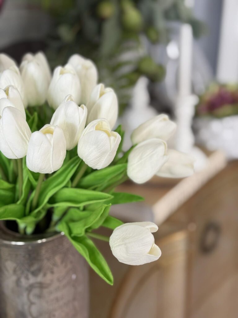 White tulips in a thrifted tea tin.