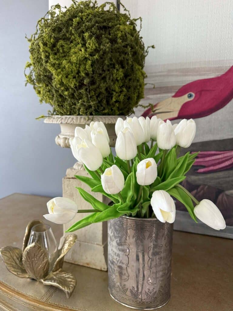 White tulips and a green moss ball.