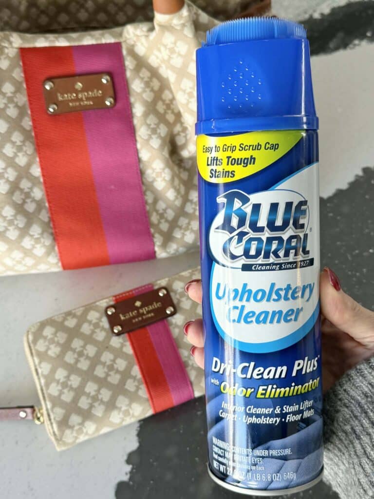 A bottle of Blue Coral Upholstery Cleaner used for cleaning a canvas bag.