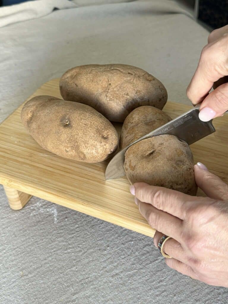 Cutting a potato in half.