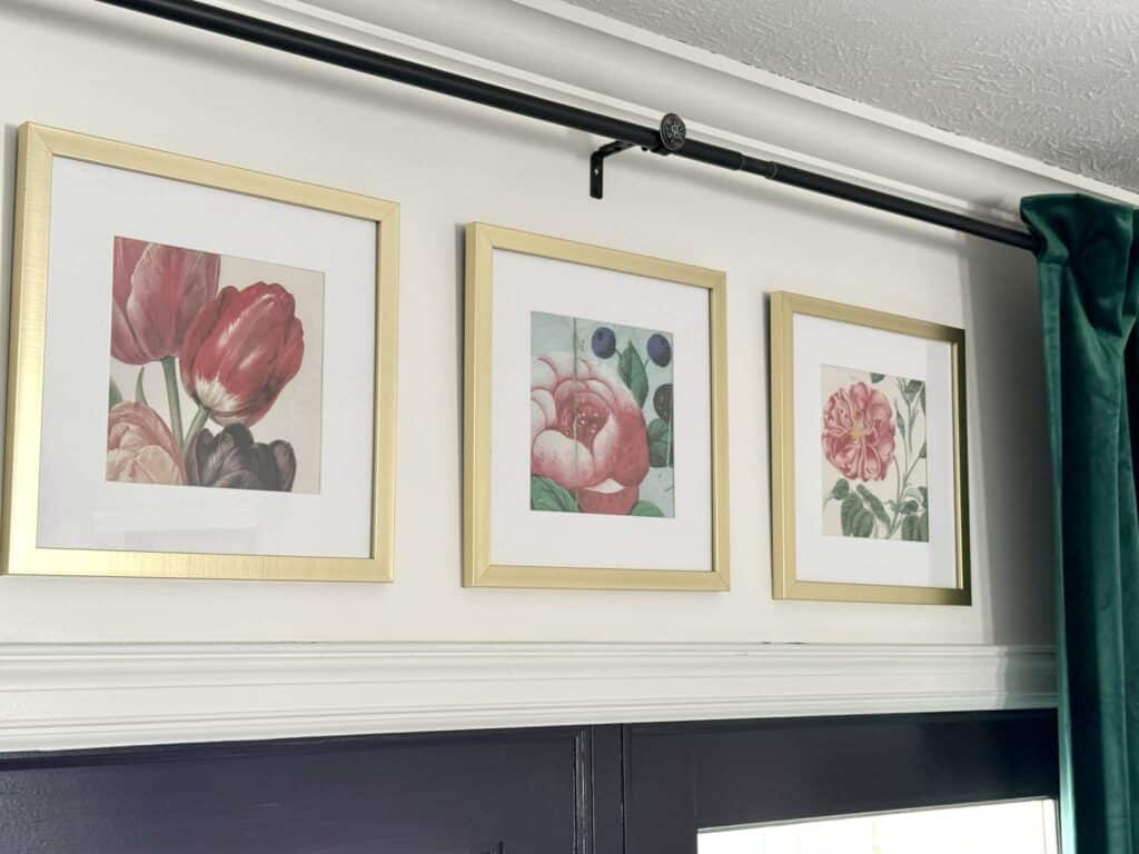 Pink floral prints in gold frames.