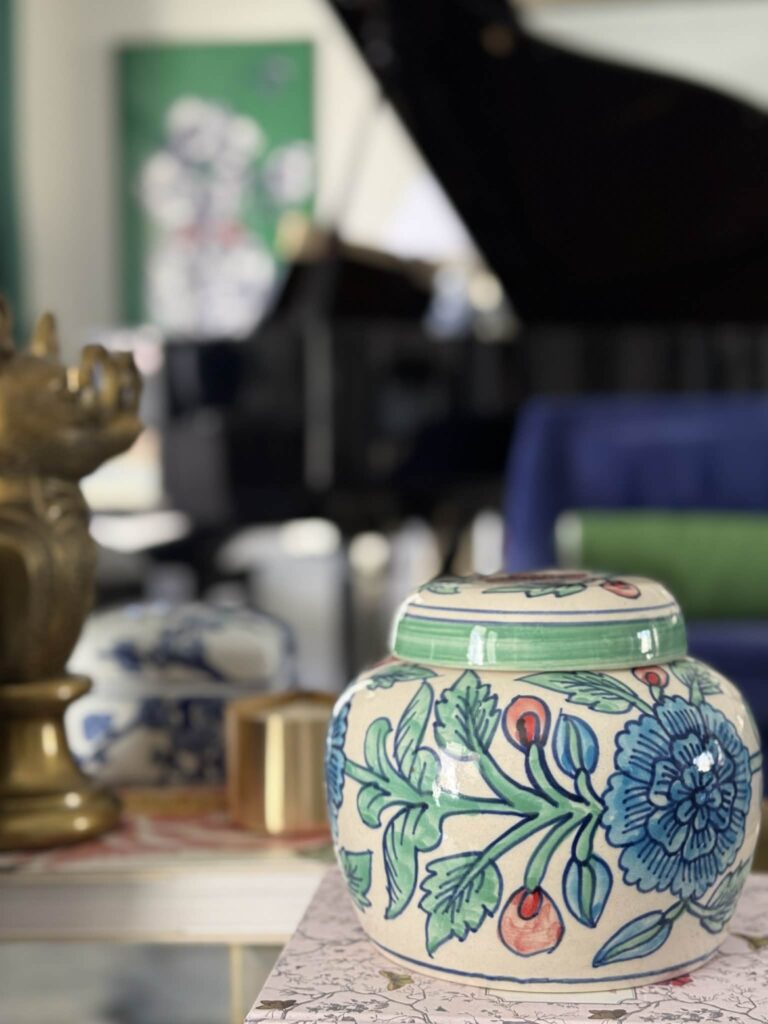 A blue and green vase in a living room.