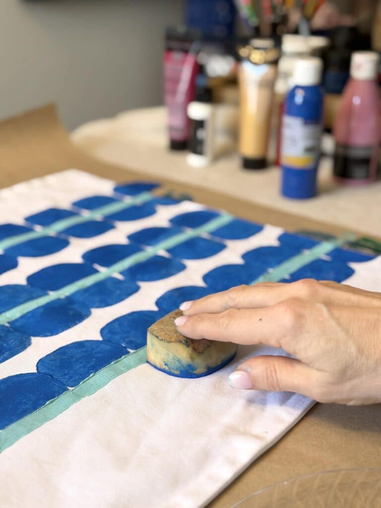 Potato printing a custom pattern on a pillow cover.