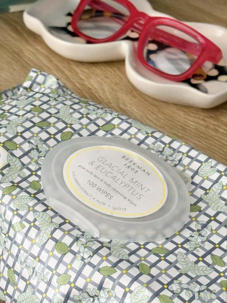 Beekman 1802 facial wipes sitting on a nightstand.