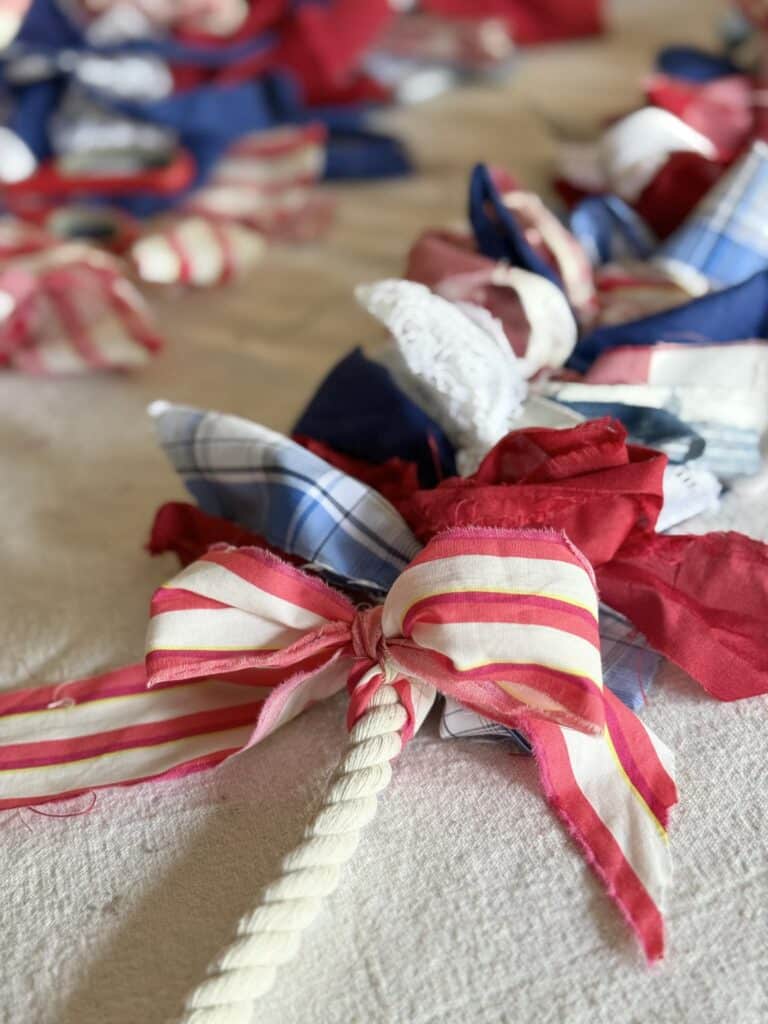 Fabric bows tied onto a rope to create a garland.