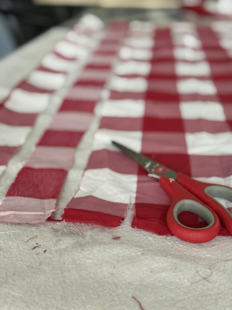 Cutting strips of fabric for a rag garland.