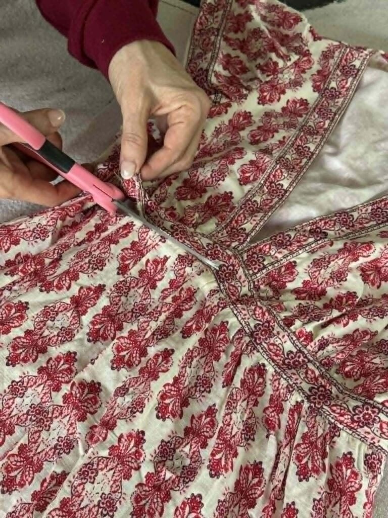Cutting a dress bodice from the skirt of a dress.