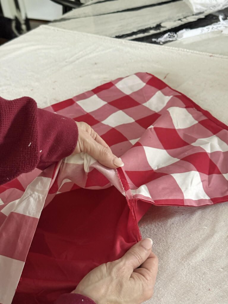 Tearing the top and bottom of a pillow sham apart.