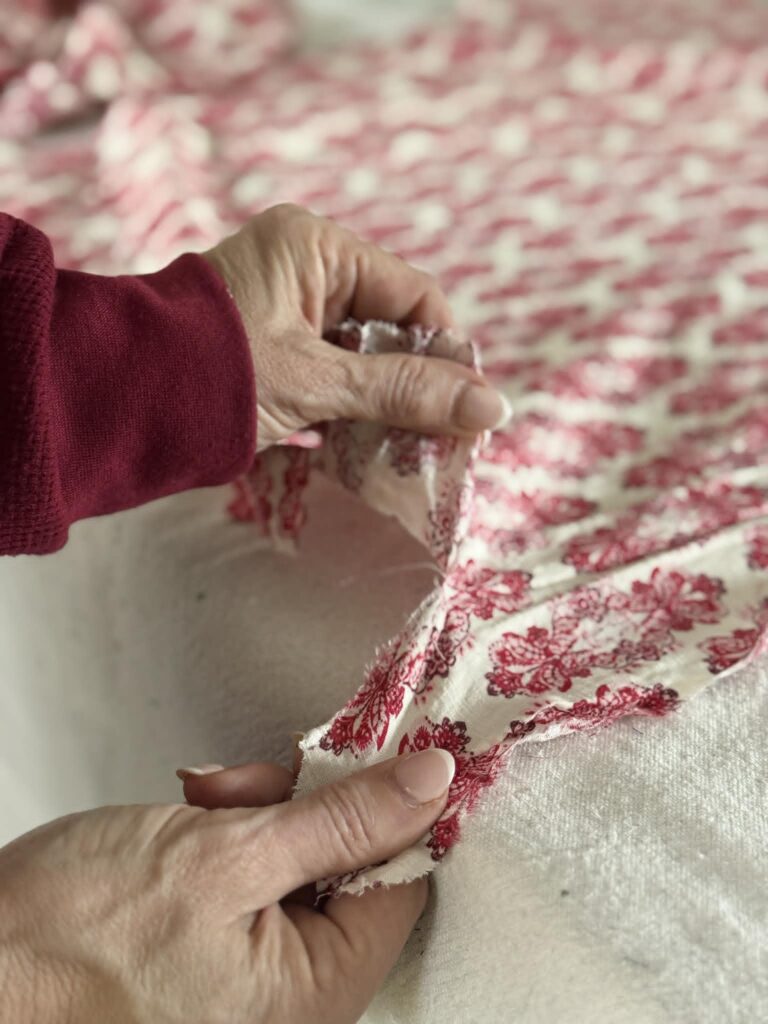 Tearing strips from cloth for a DIY fabric garland.