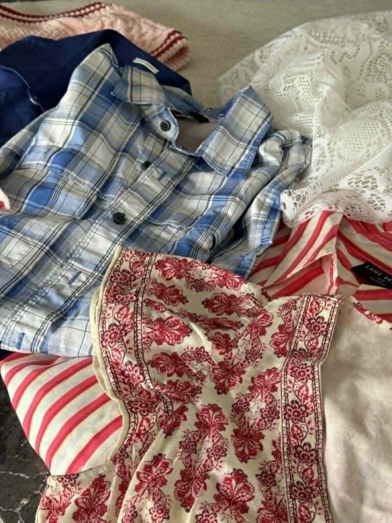 Thrift store clothes in various colors and patterns for a fabric rag garland.