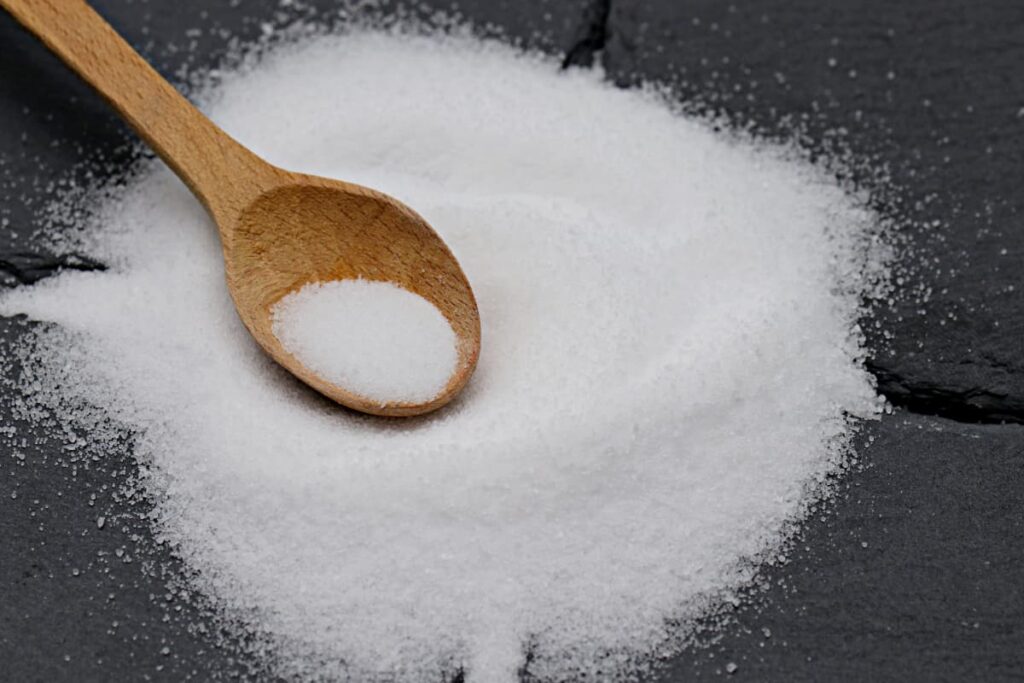 A pile of epsom sal with a wood spoon.