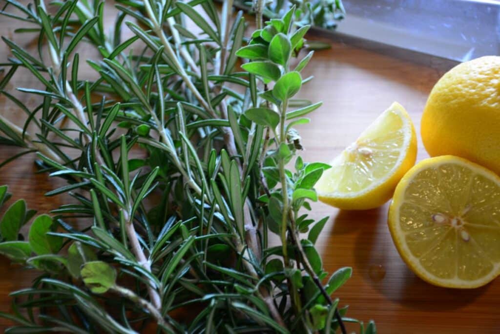 Cut lemons and fresh rosemary herbs in the kitchen.