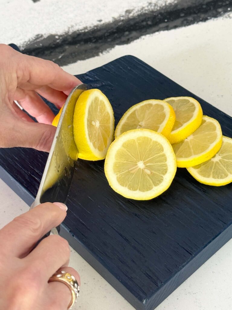 Slicing fresh lemons for lemon kitchen decor ideas.