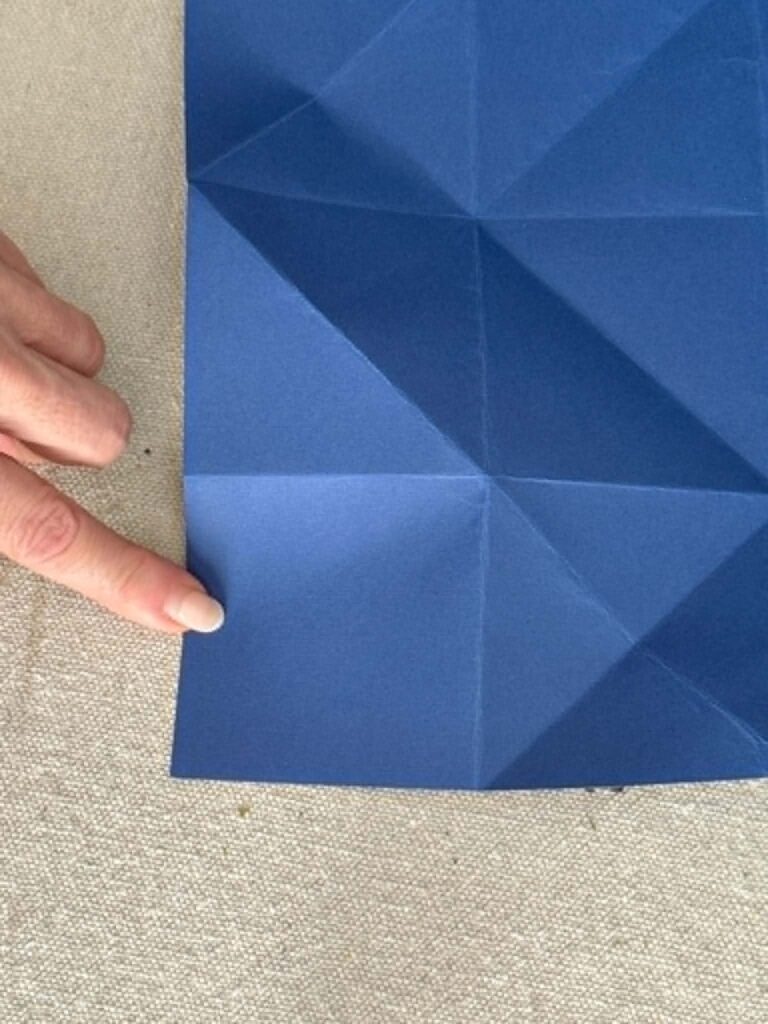 The corner of a piece of blue card stock paper.