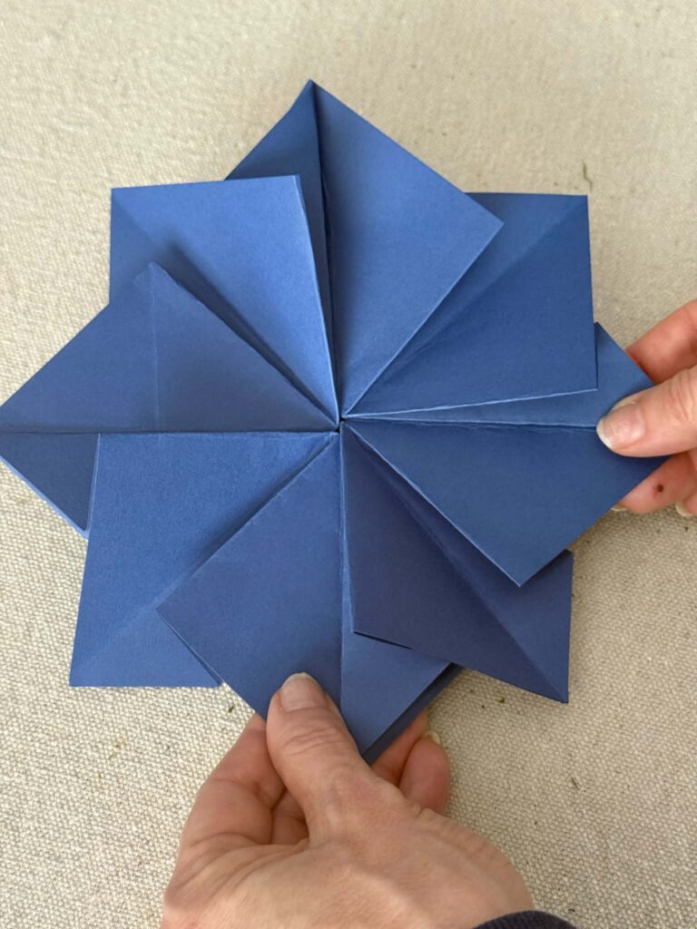 An origami envelope in the shape of a flower.