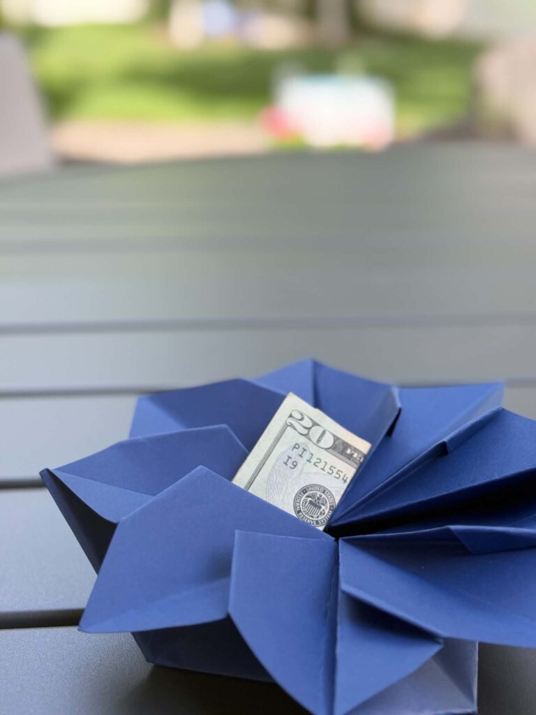 A twenty dollar bill tucked into an origami envelope.