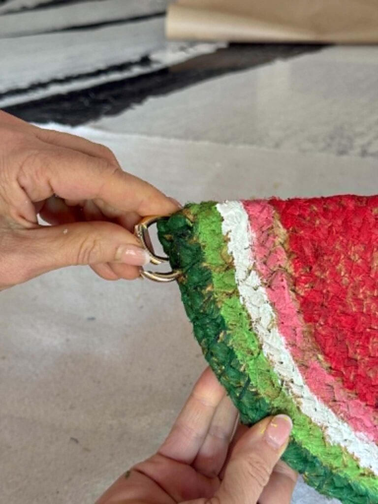 Clipping an O-ring onto the side of a watermelon door hanger.