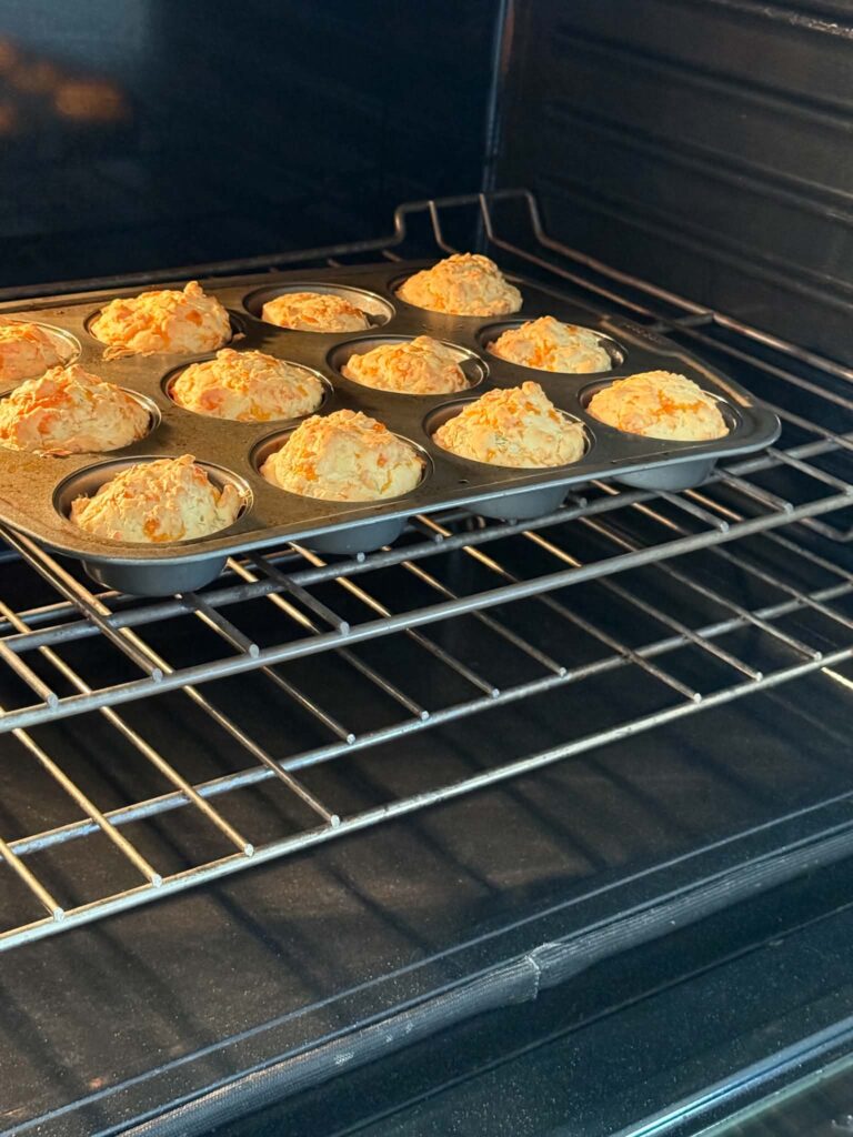 cheddar dill muffins baking in the oven.