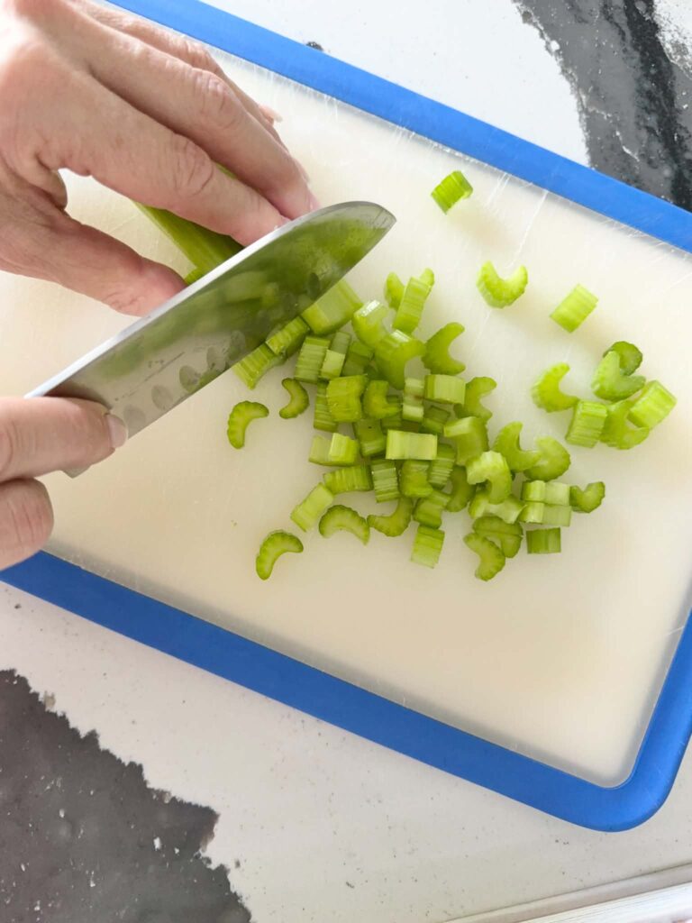 Woman chopping celery.