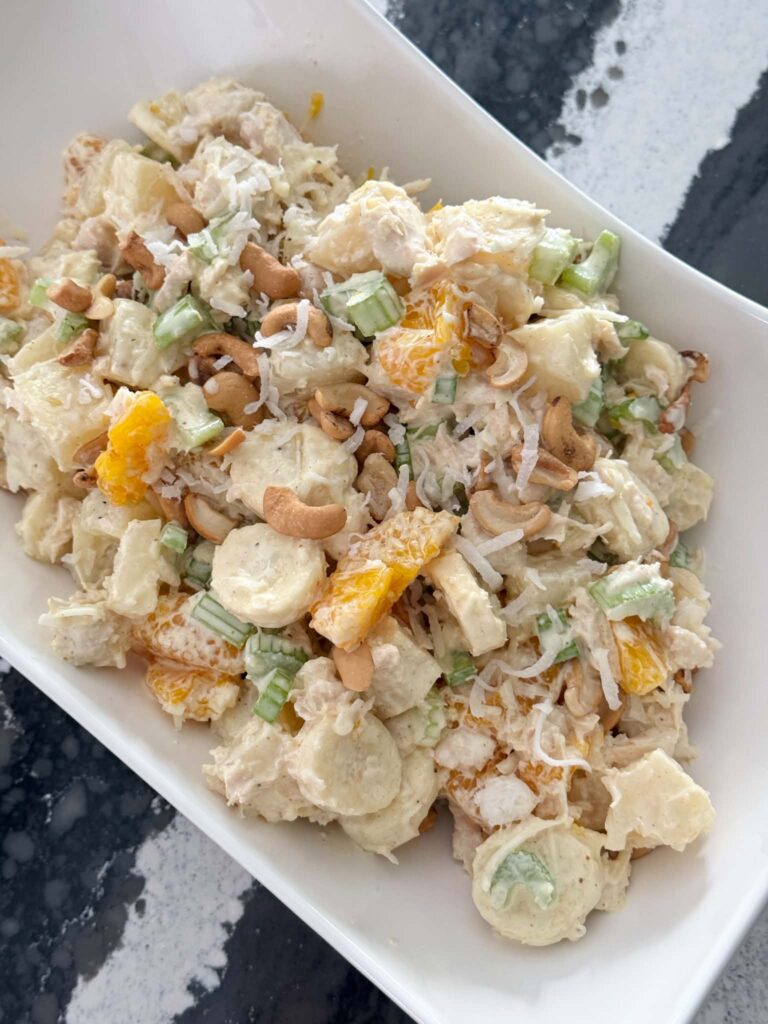 A bowl full of curry chicken salad.