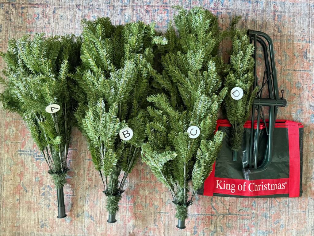 The four pieces of an artificial Christmas tree ready for assembly.