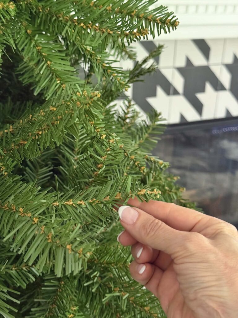 Strong, lush, deeply colored needles on the branch of am artificial King of Christmas Yorkshire Slim Fir tree.