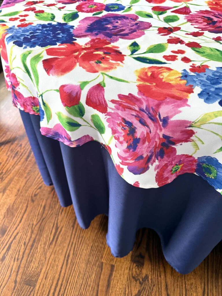 Layered tablecloths with a bold floral pattern.