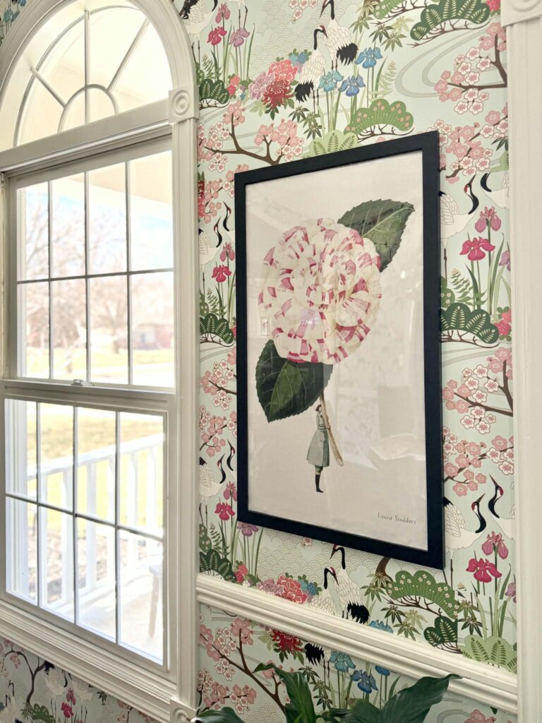 A framed tea towel in a dining room.