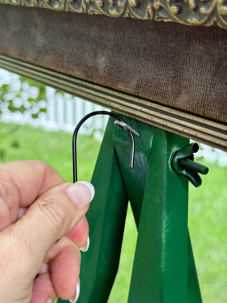 Hanging a flower basket onto an easel and frame for what to do with old picture frames.